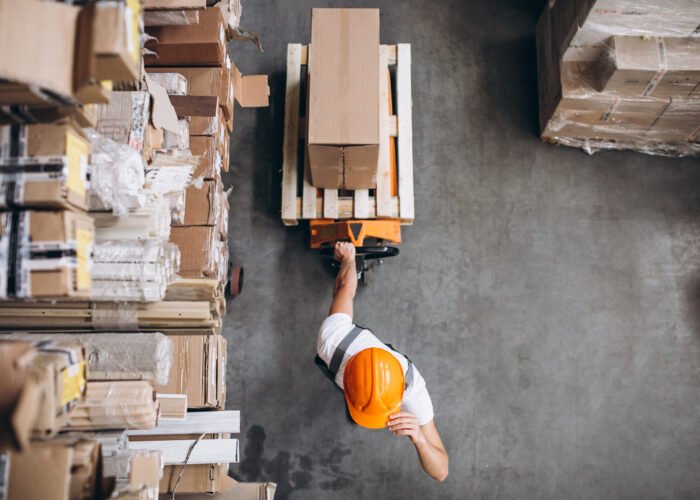 Young man working at a warehouse with boxes
